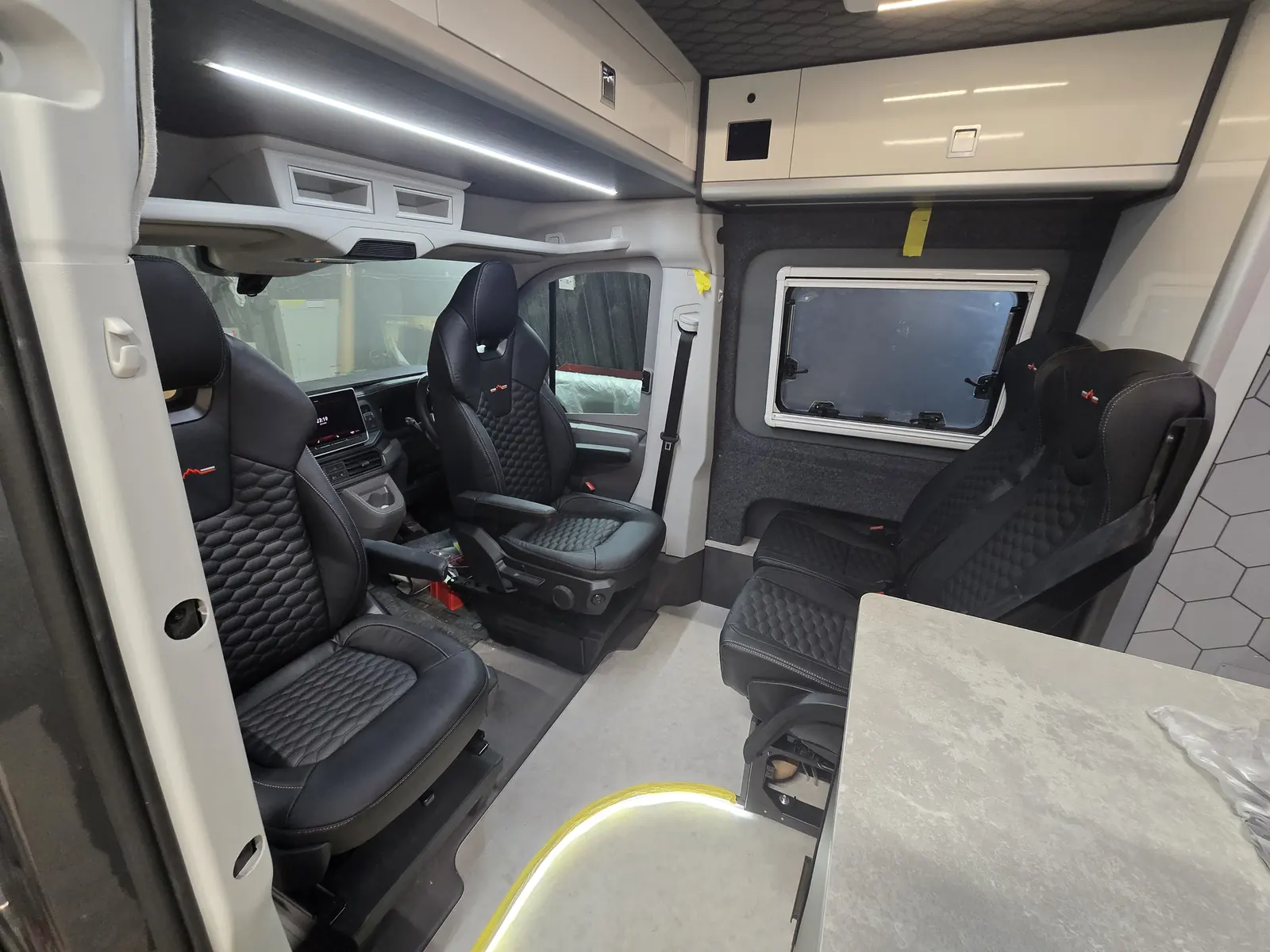 Swivel seats and a marble-effect table in a finished VANZ build