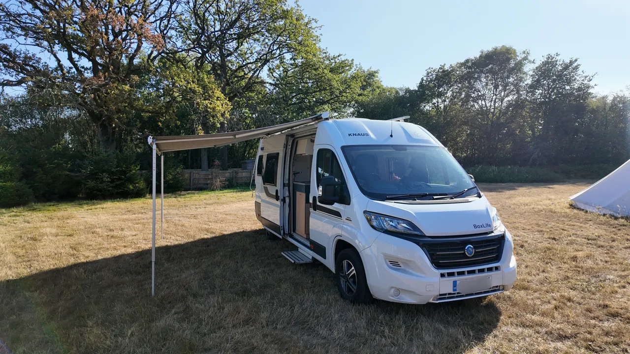 The VANZ hire camper parked on grass with its awning out